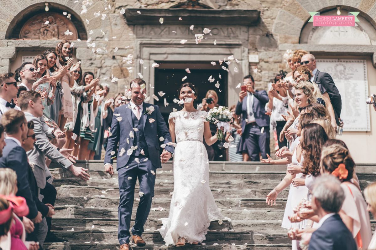 bride and groom portrait wedding in italy colour cortona tuscany confetti on steps at town hall